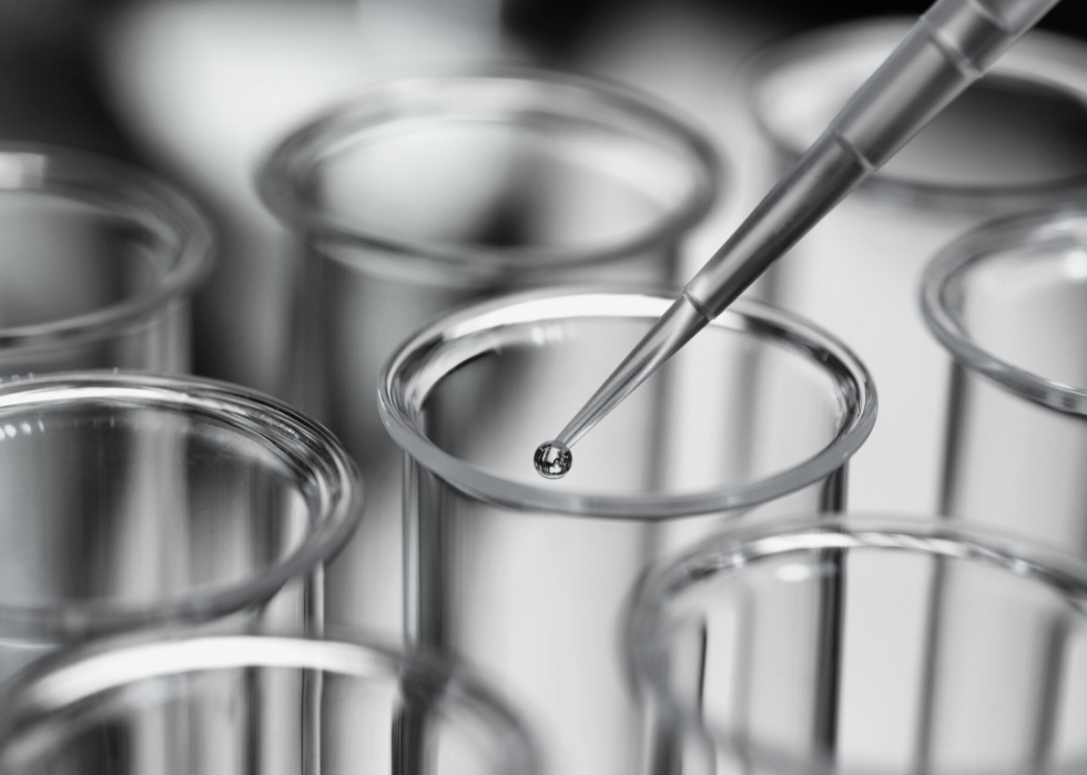 Close-up view of pipette and test tube in a laboratory.