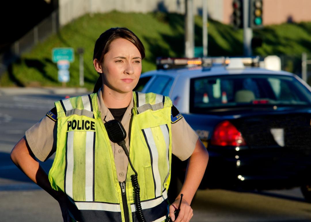 Woman police officer surveys area during a shift.