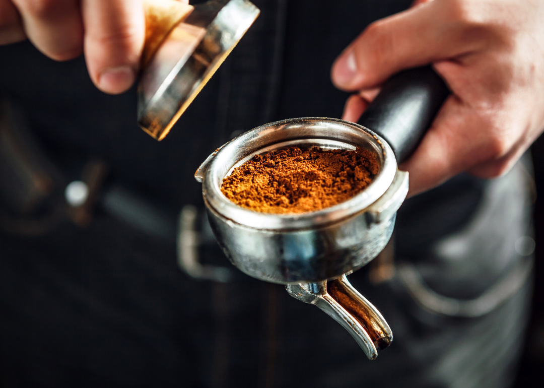 Barista preparing ground espresso.