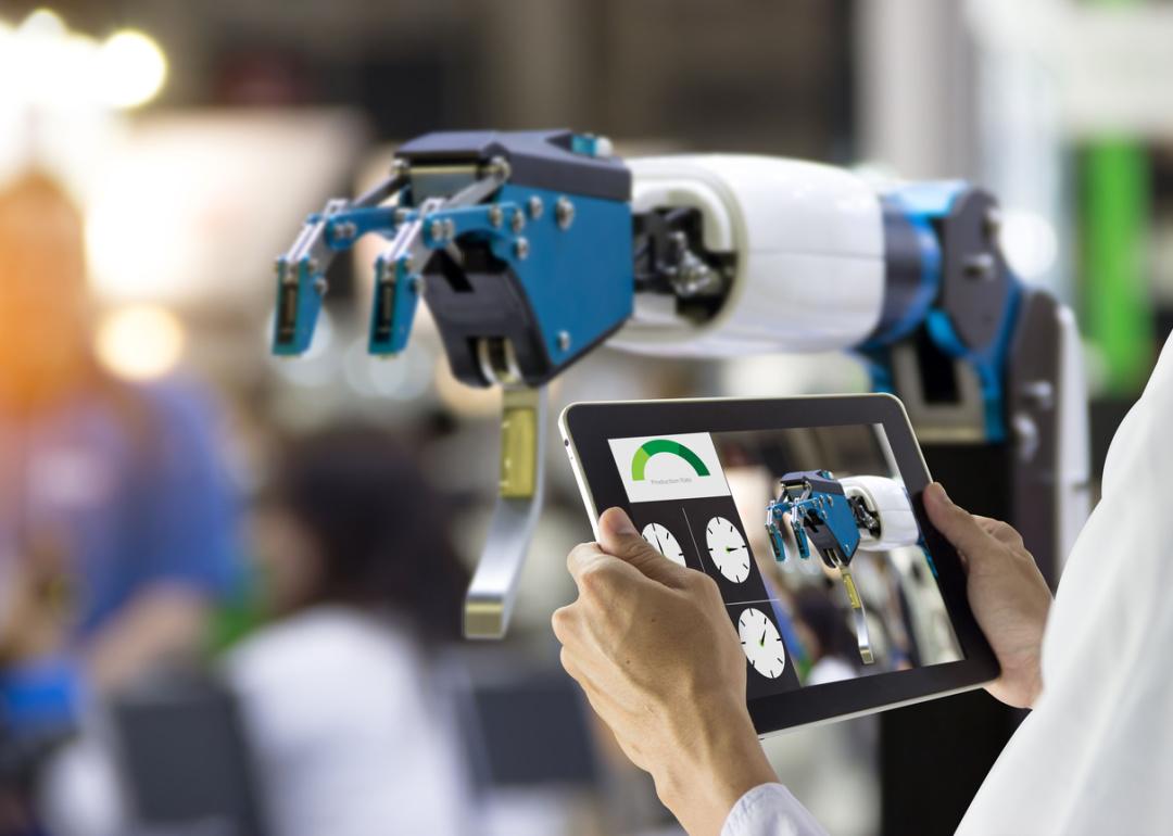 Engineers working with robot arm.