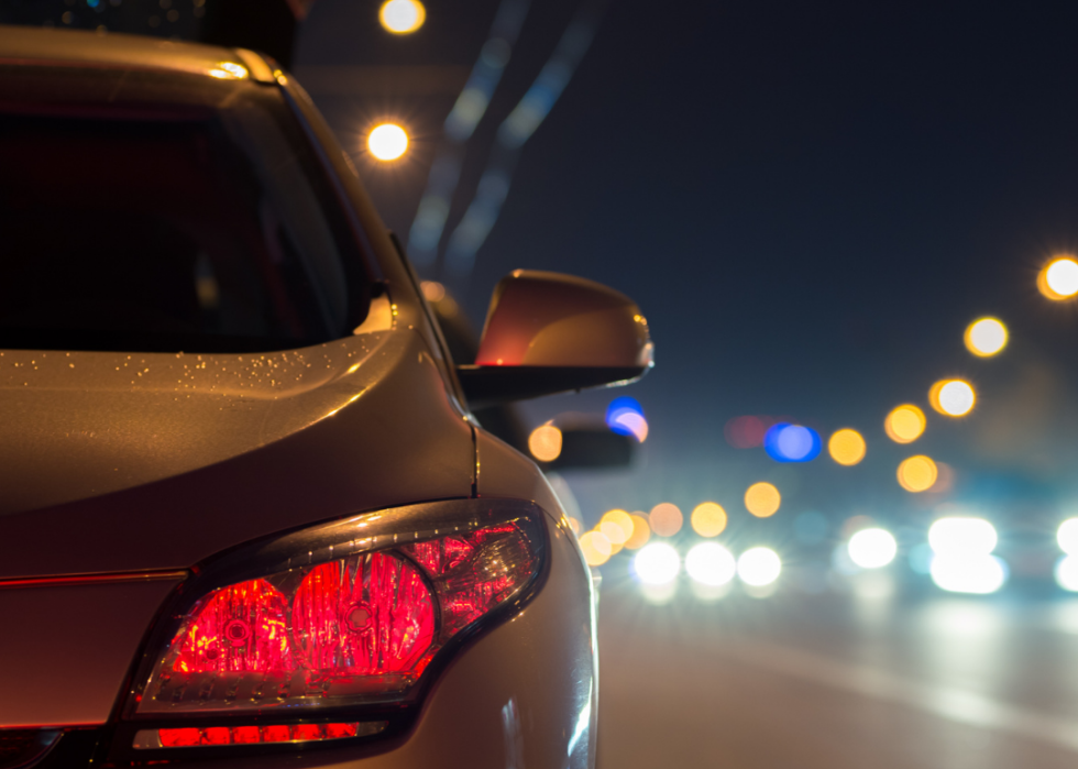 Car stopped on urban highway at night