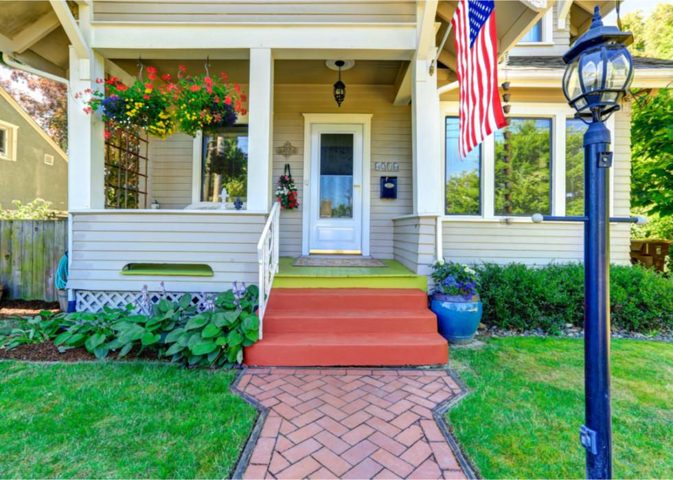 House entrance with porch and American flag.