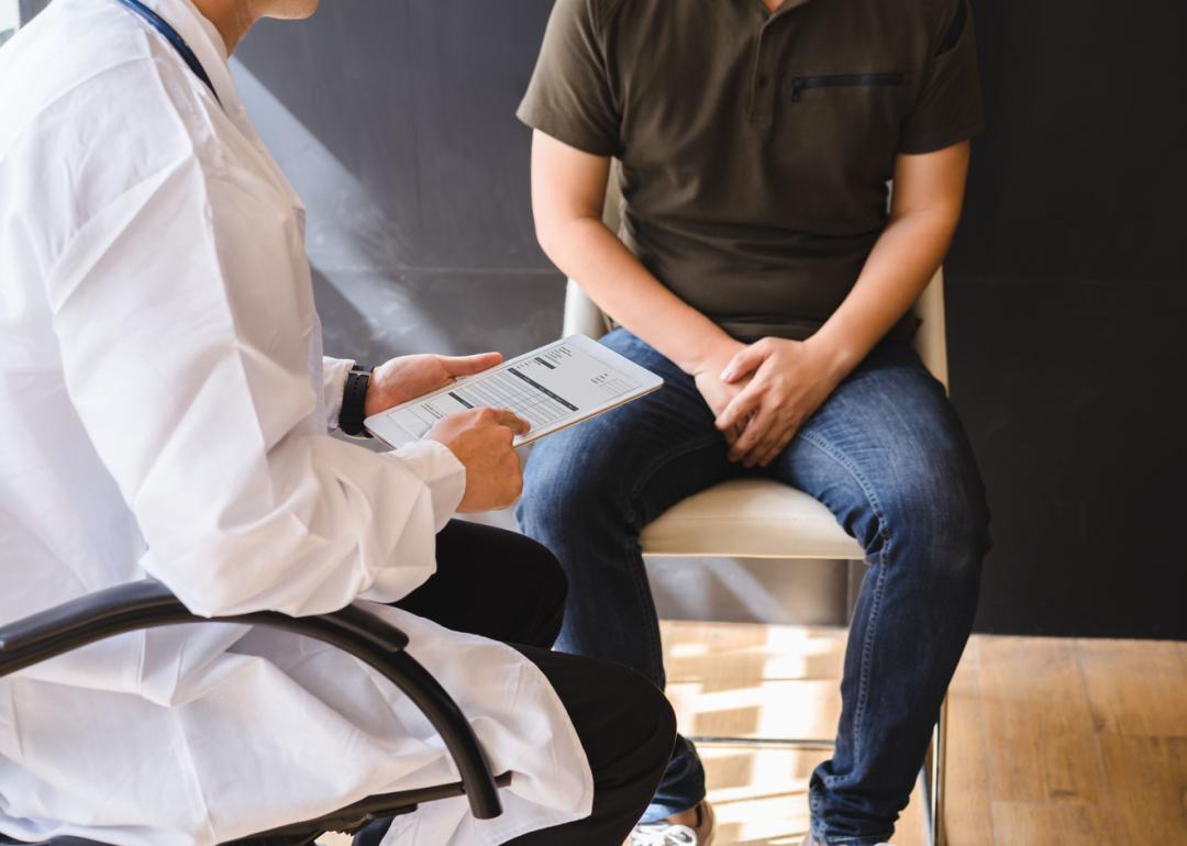 Man discussing pain with doctor.