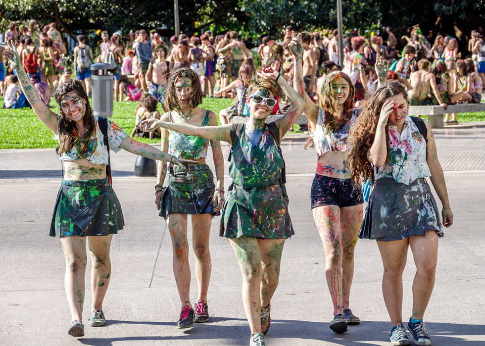 Students participating in graduation celebration in park.