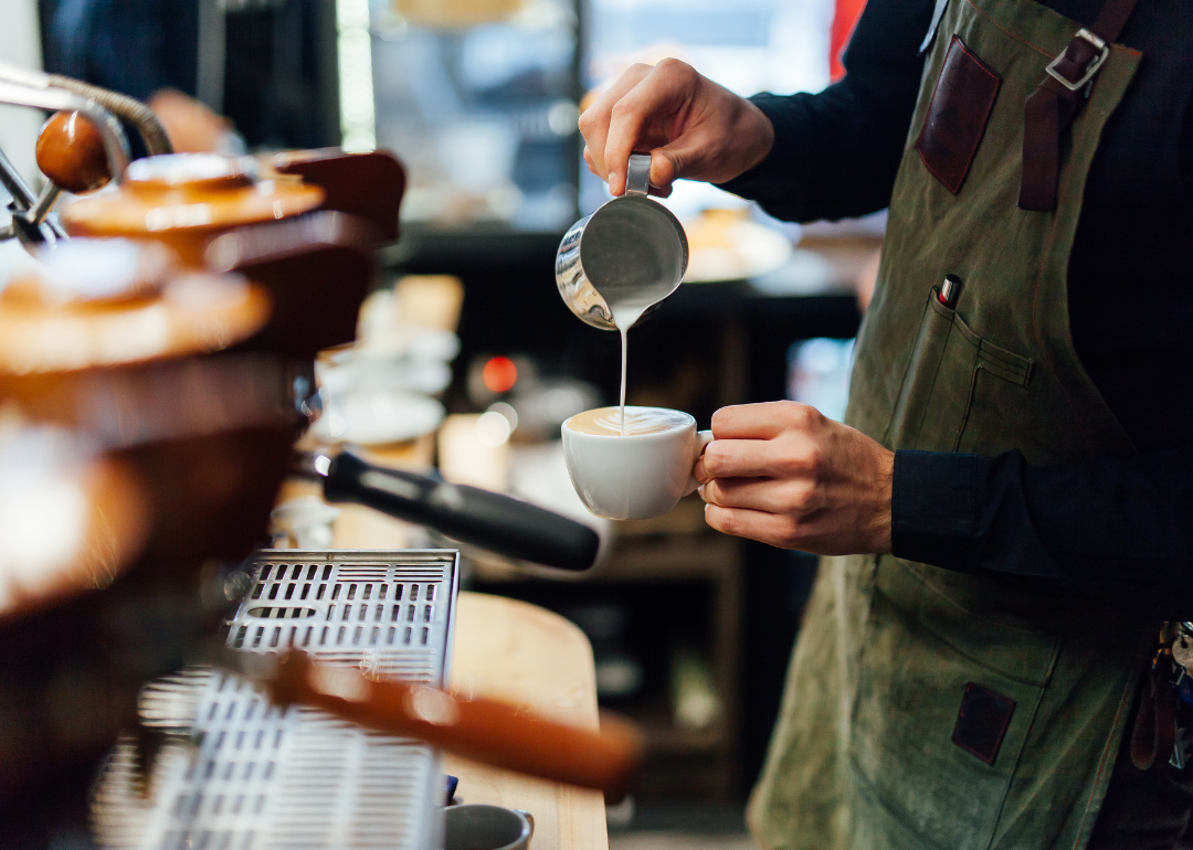 Barista preparing latte.