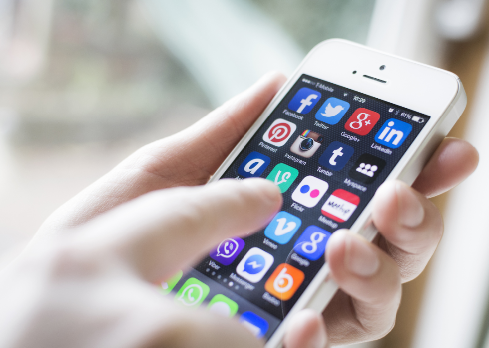 Hand on smartphone showing apps