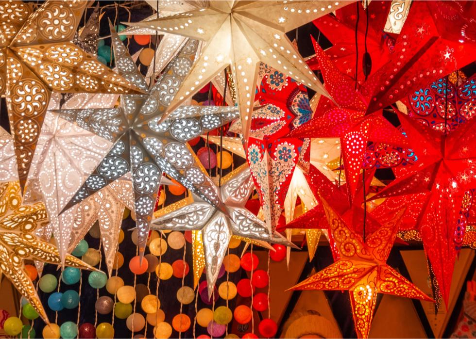 White and red star shaped lanterns hand from a ceiling. 