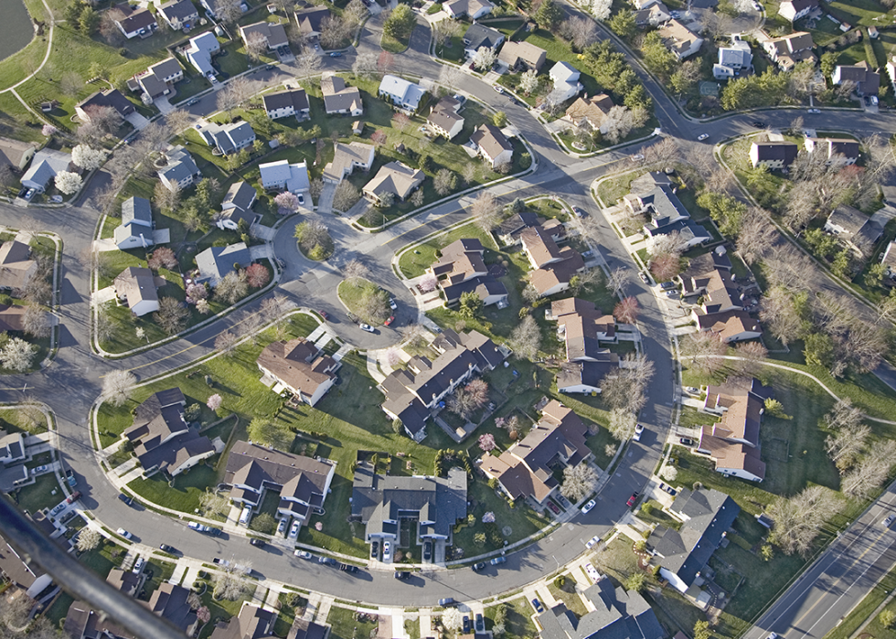 Aerial view suburban homes and trees.