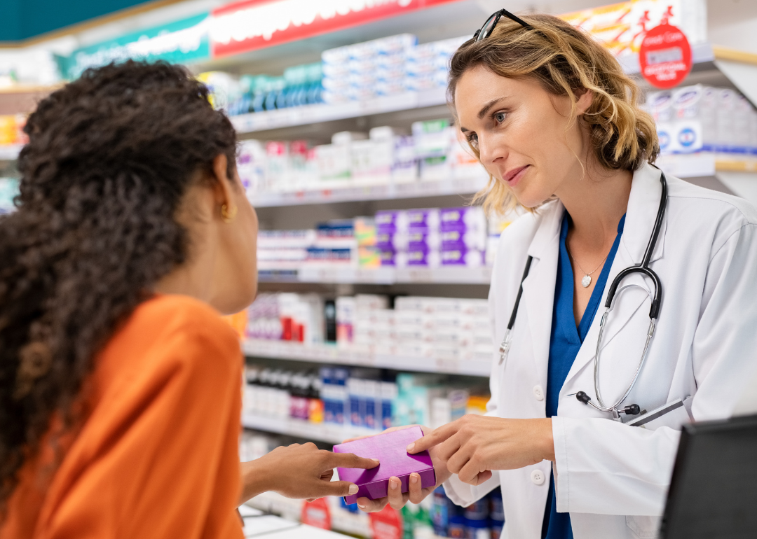 Pharmacist discussing medication with customer.