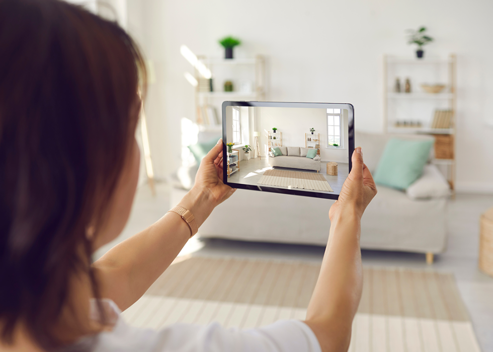 Person taking interior photos on tablet.