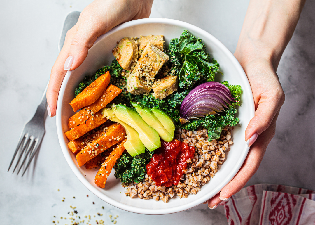 Hands holding vegan lunch salad.