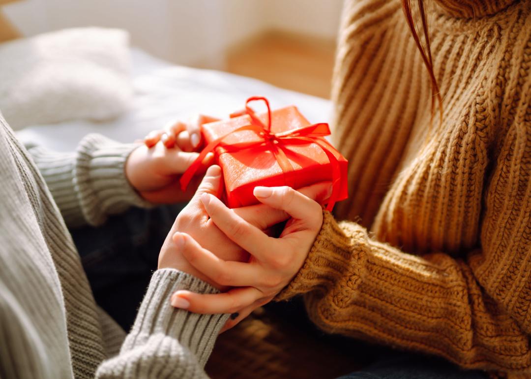 Close-up view on couple exchanging gifts.