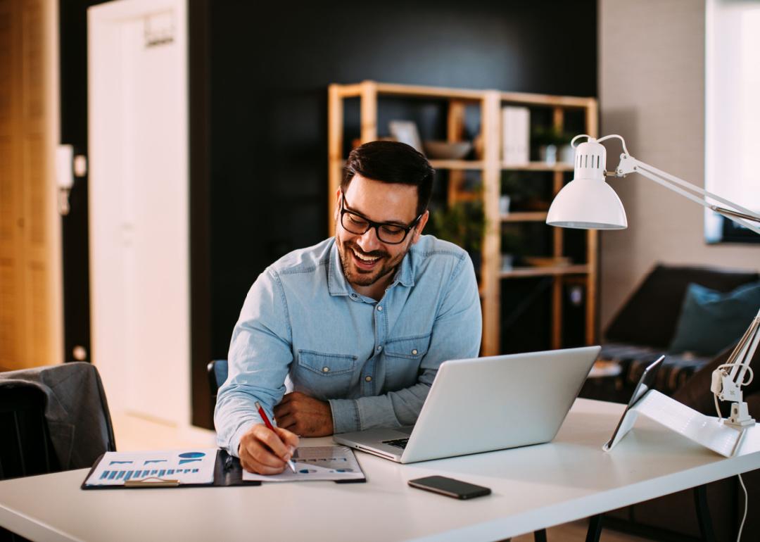 Professional working in home office on financial reports.
