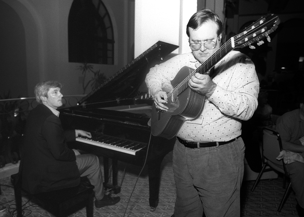 Paul Allen with guitar plays with Jerrold Kaplan on piano at PC Forum.