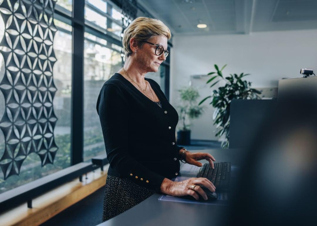 Professional woman at standing desk in office.