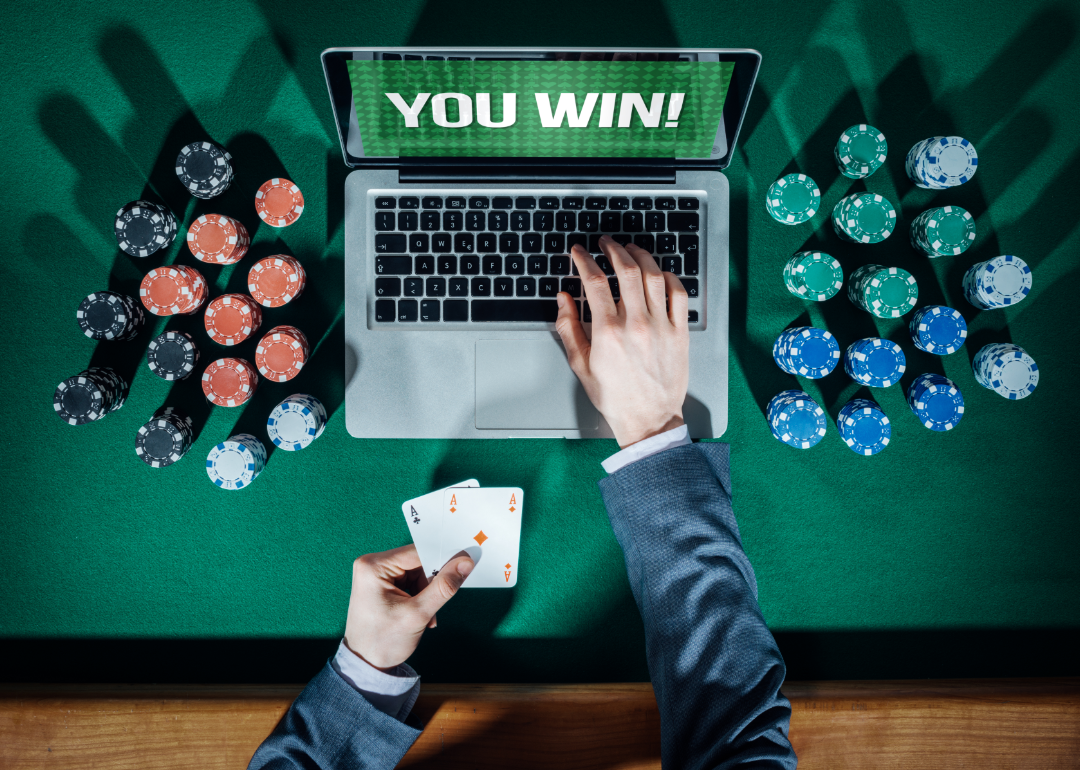 Person playing online poker with the words “You Win!” on the screen.