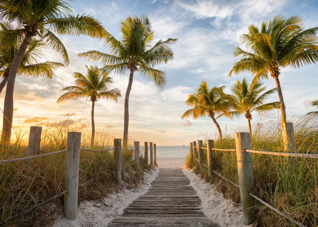 Footbridge to sunrise on beach.