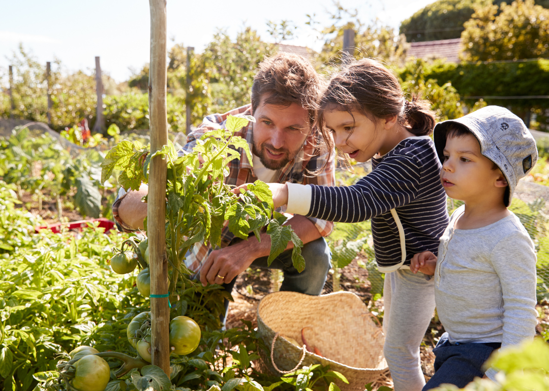 Father with daughters in garden.