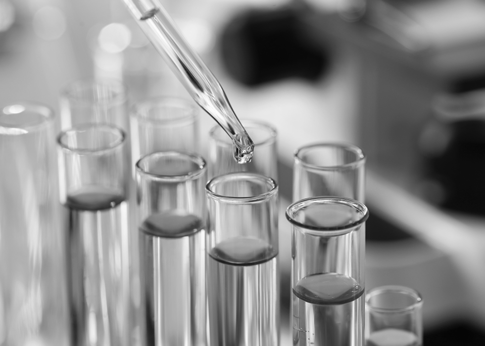 Dripping liquid from pipette into test tube in laboratory,