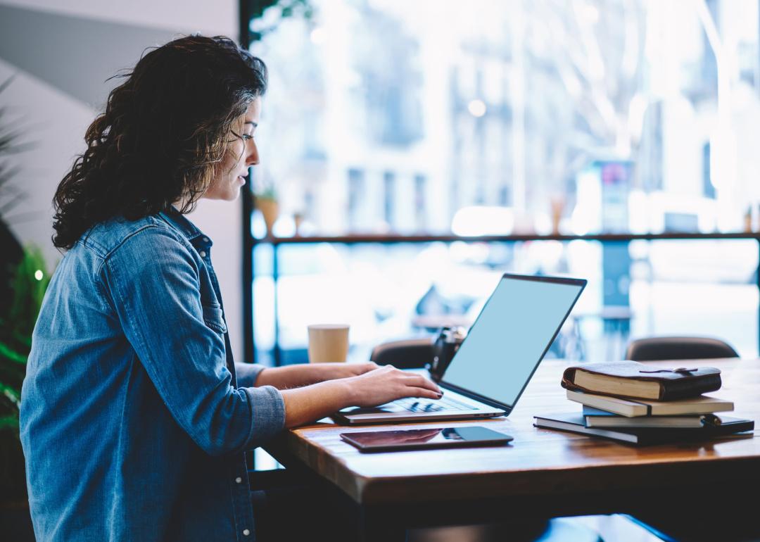 Woman looking at laptop screen in office.