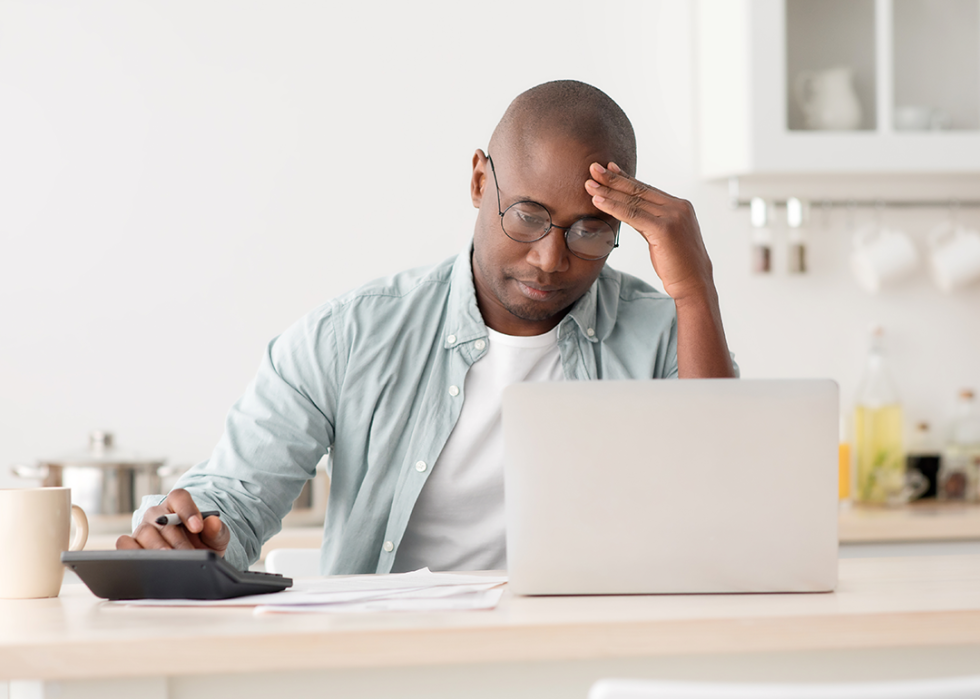 Concerned man reviewing bills.