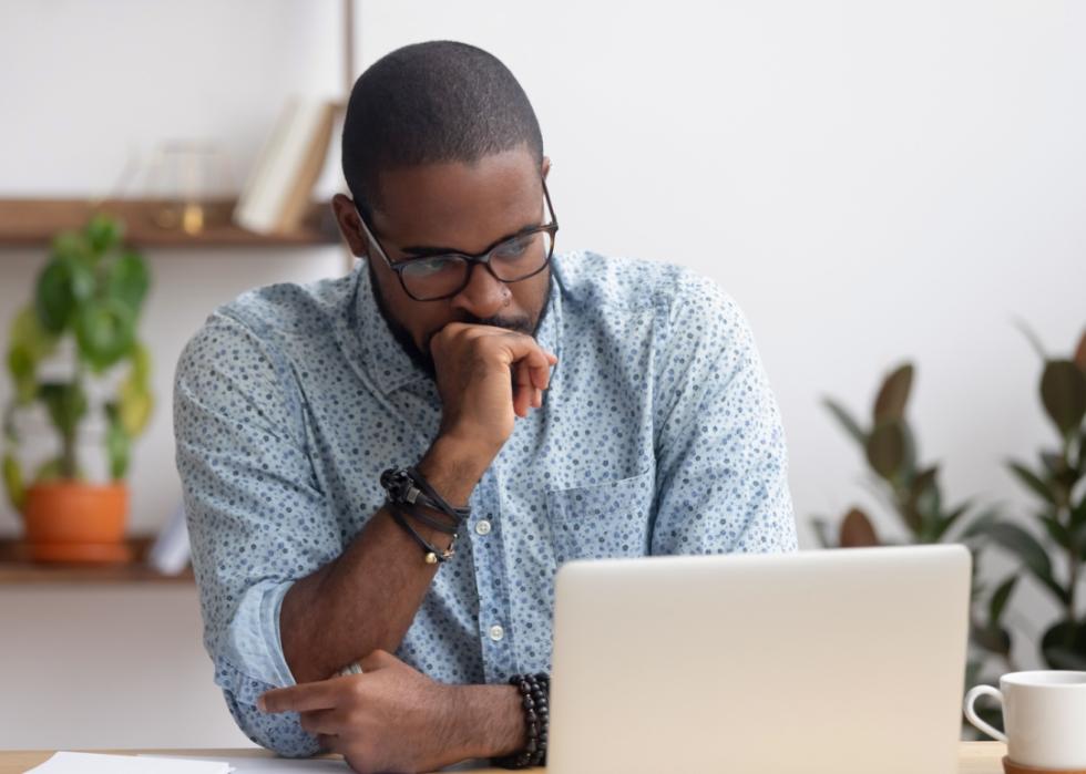 Professional man looking at laptop.
