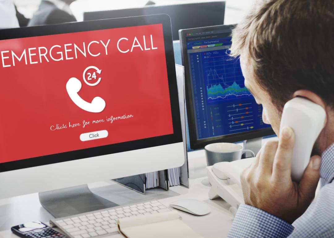 Emergency call dispatcher worker at terminal.