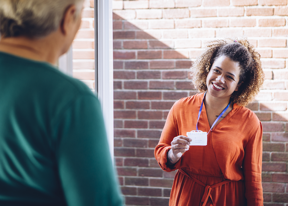 Social worker showing badge at the front door.