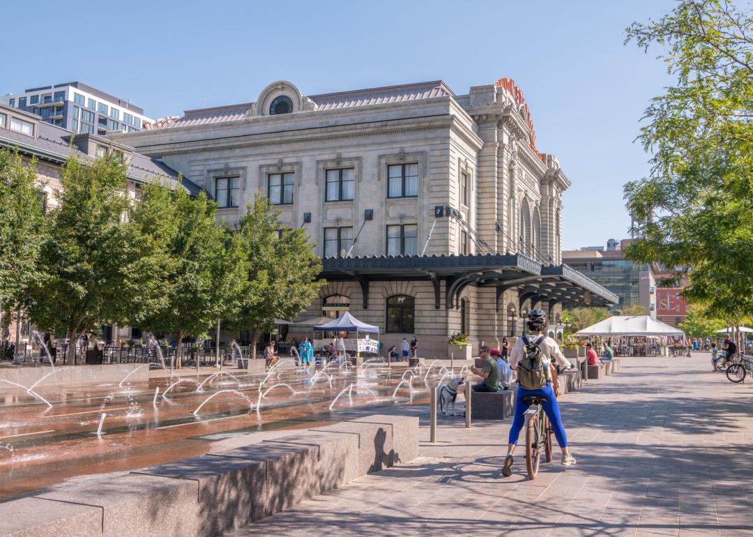 A person rides a bicycle in the plaza at Union Station in Denver