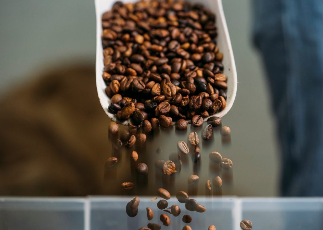 Close up of scoop of coffee beans.