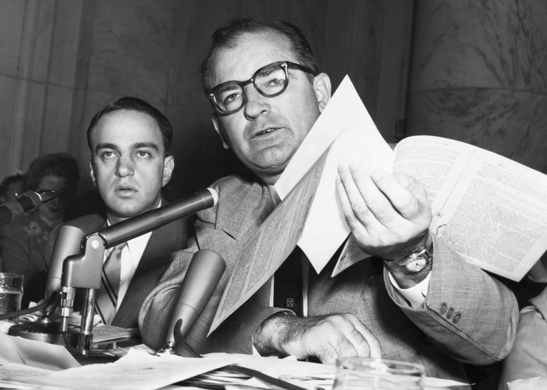 Senator Joseph R. McCarthy holding documents during McCarthy investigations.