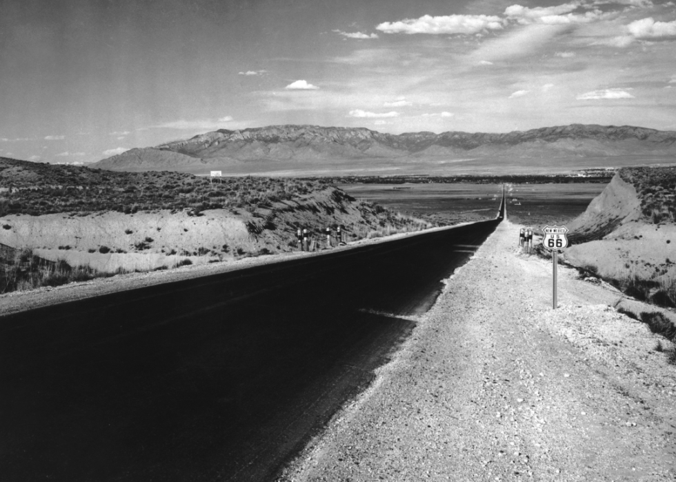 Newly paved road through desert with New Mexico U.S. 66 sign.