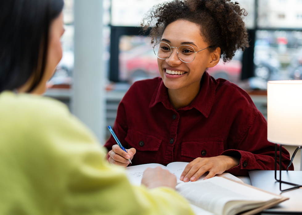 Two college-aged people studying together at a table.