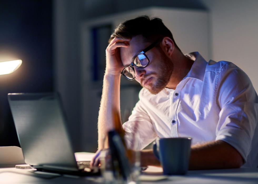 Stressed businessman working at night.