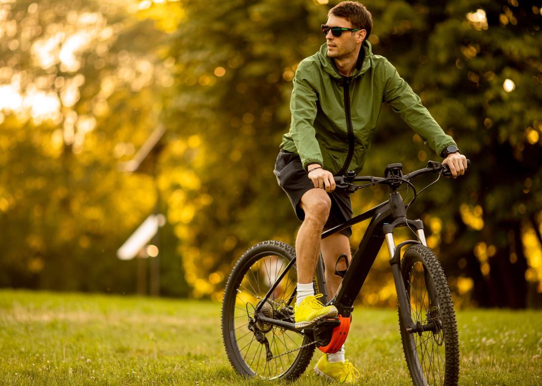 Man riding an electric bike in the park.