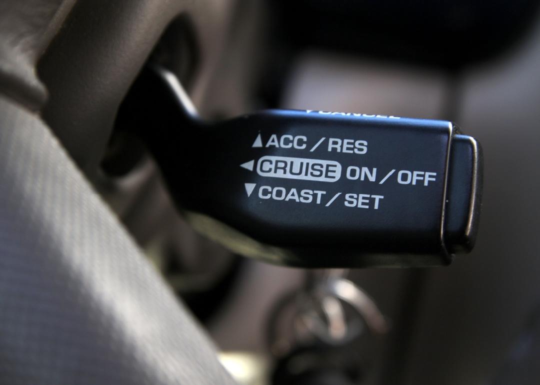 Close up on cruise control switch in car