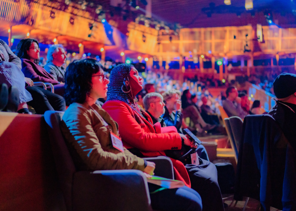 Attendees watch a live TED talk