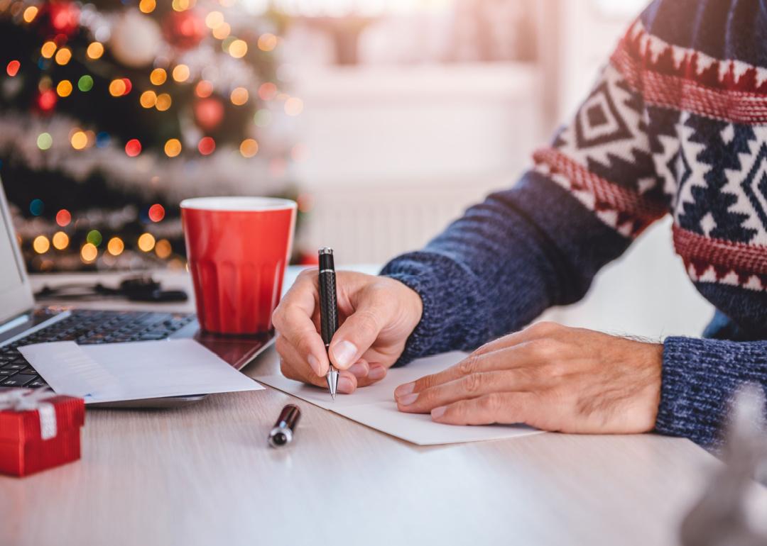 Man writing holiday cards.