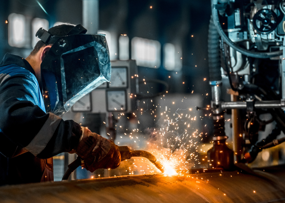 Welder working in factory.