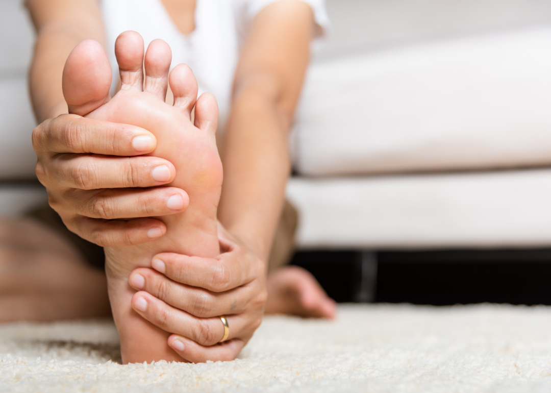 Woman holding foot.