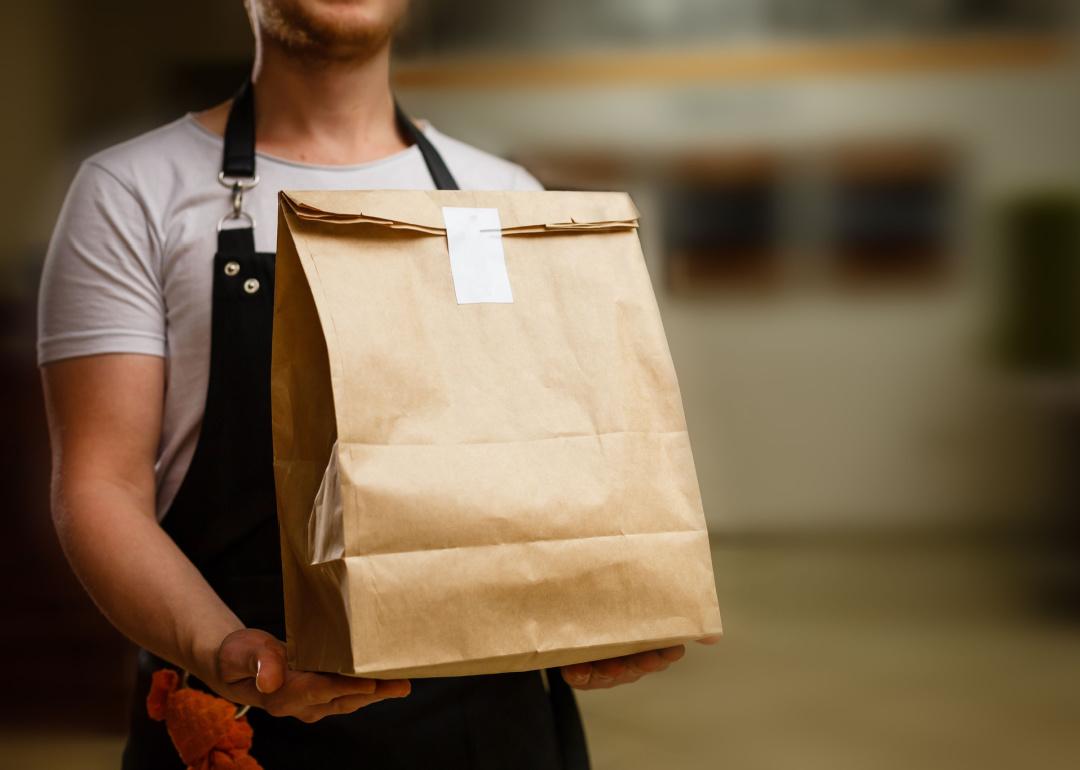Person delivering to-go order.