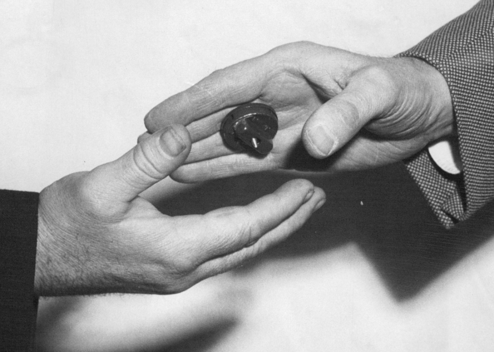 A man with a Joy-Buzzer reaches for a handshake.