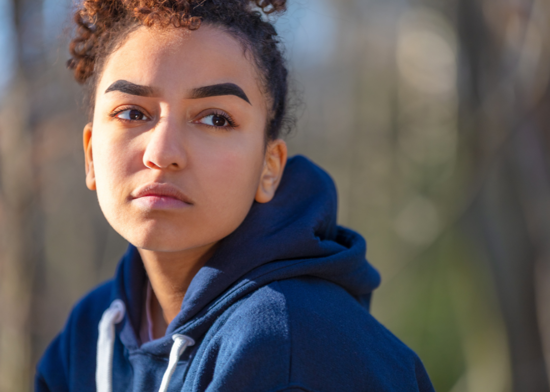 Portrait of LGTBQ+ youth with serious expression.