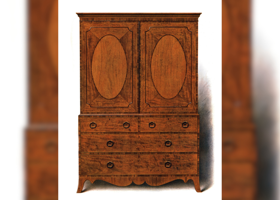 Lithographic print showing a mahogany and satinwood clothes press.