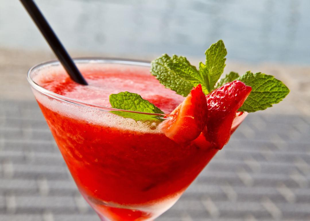 Close up strawberry daiquiri with straw.