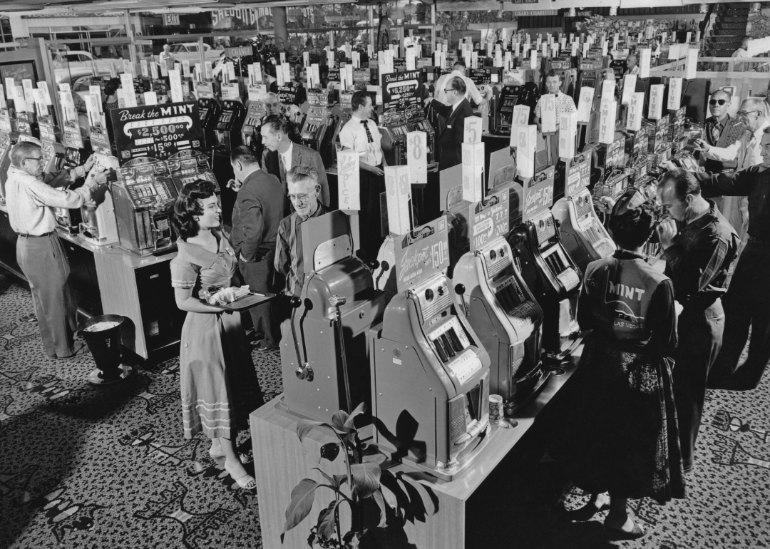 People play slot machines on The Mint casino floor.