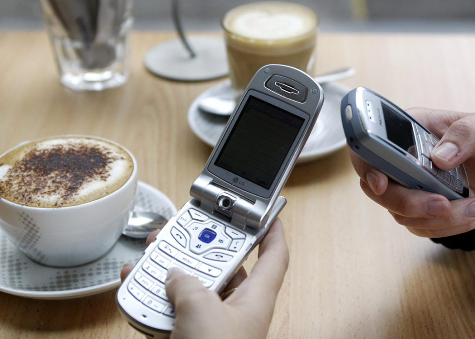 People using cell phones in coffee shop.