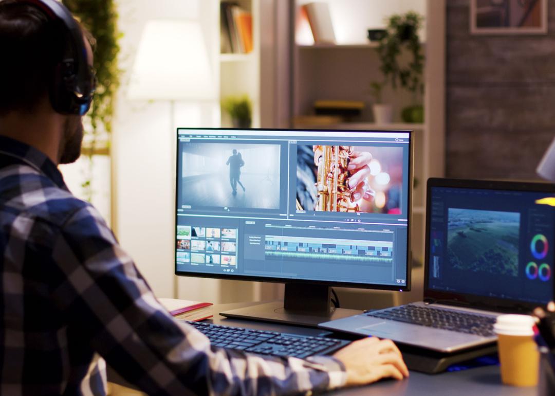 Film editor working on post production at desk.