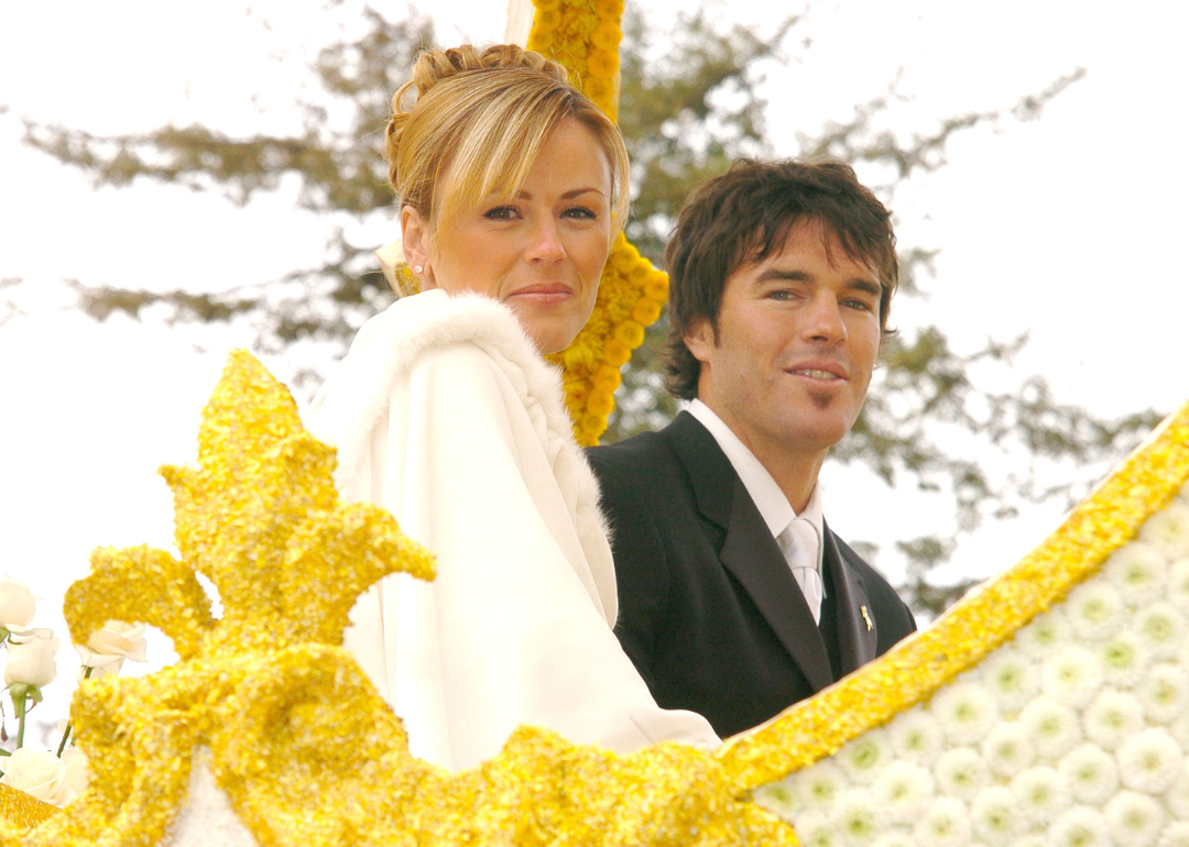 Trista Rehn and Ryan Sutter ride on float in parade.