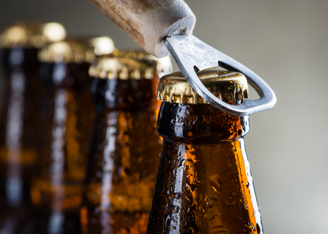 Bottle opener ready to open cold bottle of beer.